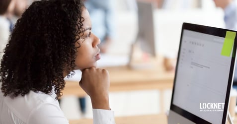 image of a woman viewing an email on her computer wondering if it is a legitimate request or if it might be an email hijacking attempt