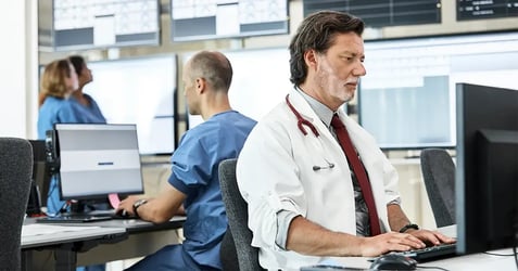 image of healthcare professionals accessing patient records on desktop computers