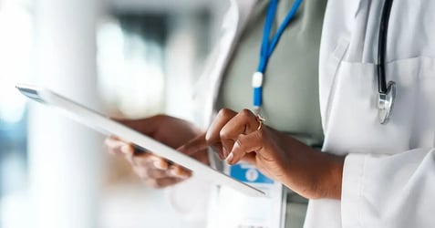image of a doctor using a tablet in a healthcare setting