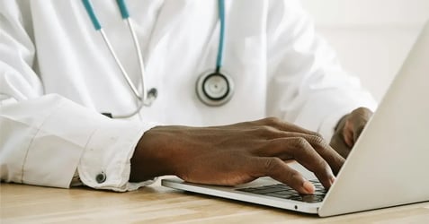image of a healthcare provider using his laptop
