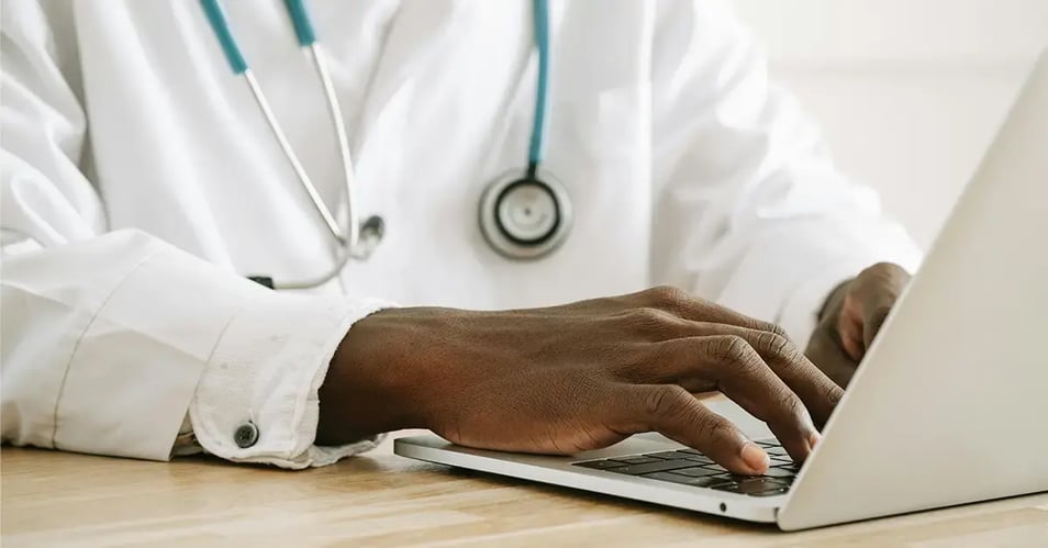 image of a healthcare provider using his laptop