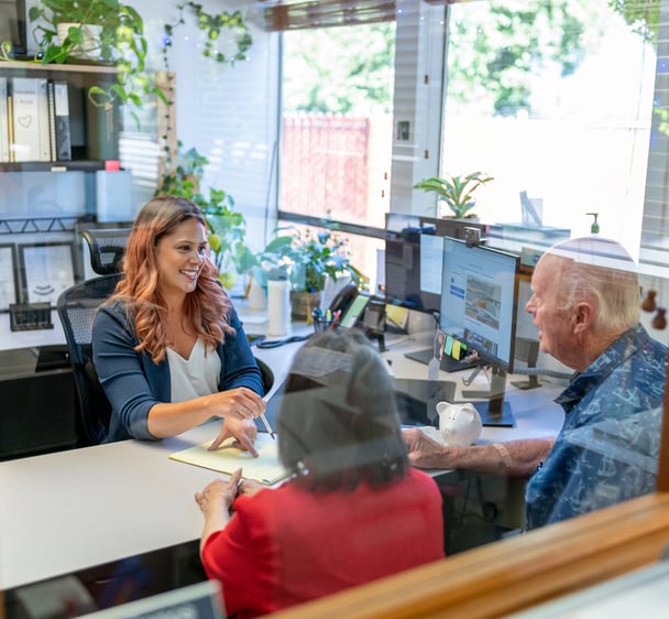Bank teller consults with customers