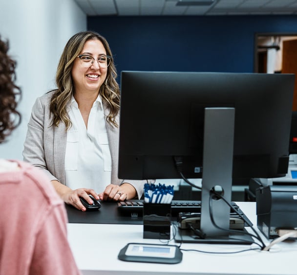 Financial consultant working with her client at computer