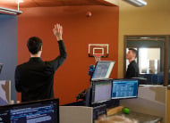 Employee shooting basketball in the office