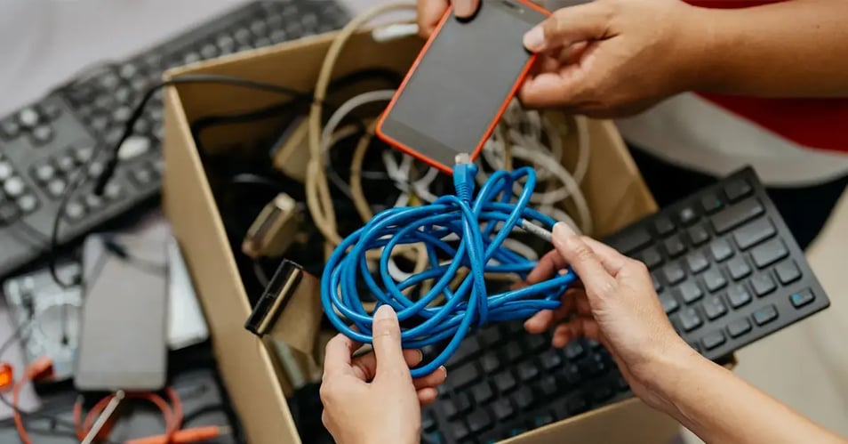 an image of old electronics in a storage box awaiting secure electronic disposal