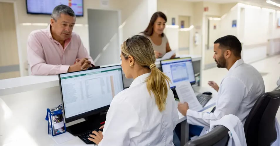 Medical office staff at a front desk representing the human perimeter in healthcare data security and patient privacy.