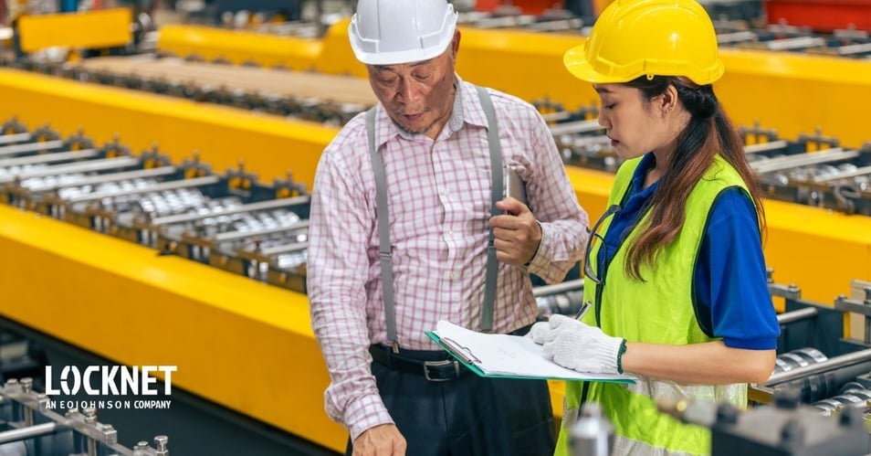 A manufacturing team conducting an internal audit and compliance check on a factory floor.