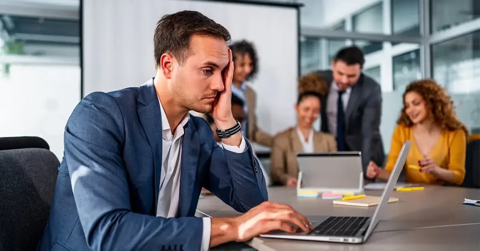 Bank president looking stressed during a board meeting after a question about IT oversight and cybersecurity risk