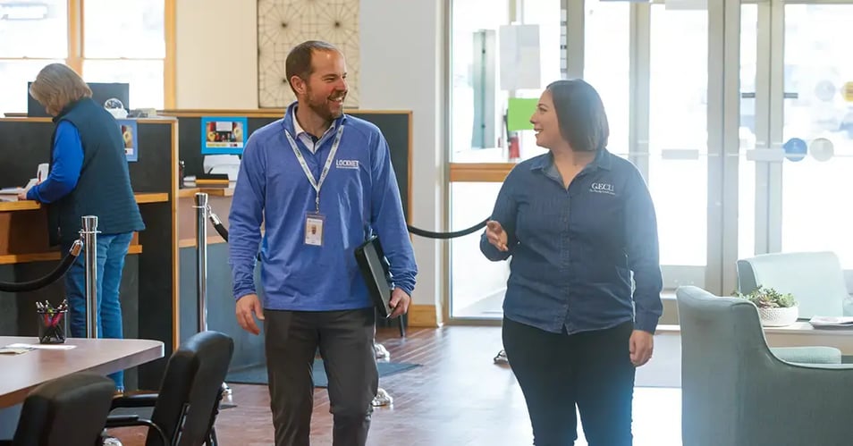 Locknet IT professional meeting with a community bank employee inside a bank branch.