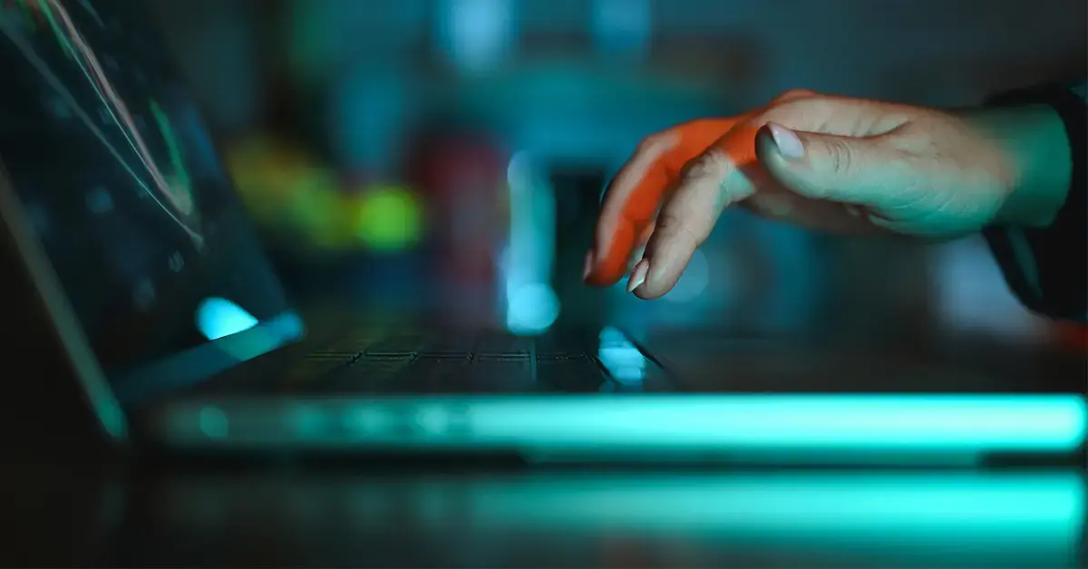 an image of someone using a laptop in a computer lab