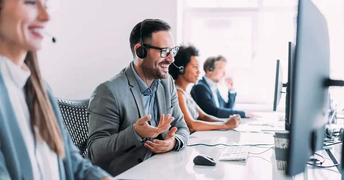 an image of call center support staff happily assisting clients in a security as a service model